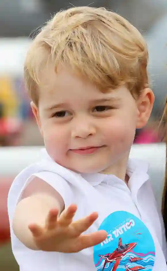 Prince George waves during a visit to the Royal International Air Tattoo at RAF Fairford on July 8, 2016 in Fairford, England