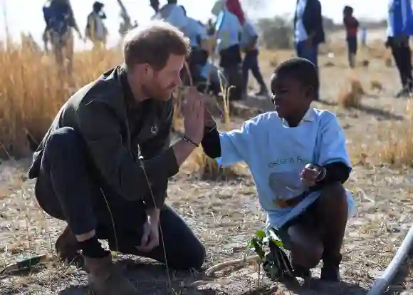 Prince Harry helps local schoolchildren to plant trees at the Chobe Tree Reserve in Chobe district, in the Northern Botswana on September 26, 2019.