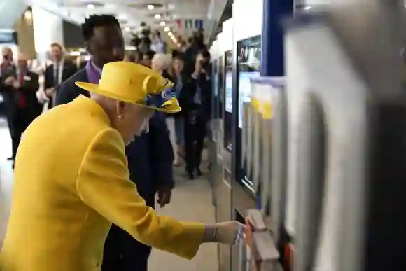 Queen Elizabeth II using a oyster card machine as she attends the Elizabeth line's official opening at Paddington Station, May 17, 2022.