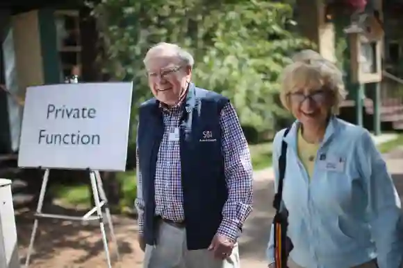 Warren Buffett, chairman of Berkshire Hathaway Inc., walks with his wife Astrid at the Allen & Company Sun Valley Conference, July 12, 2014.