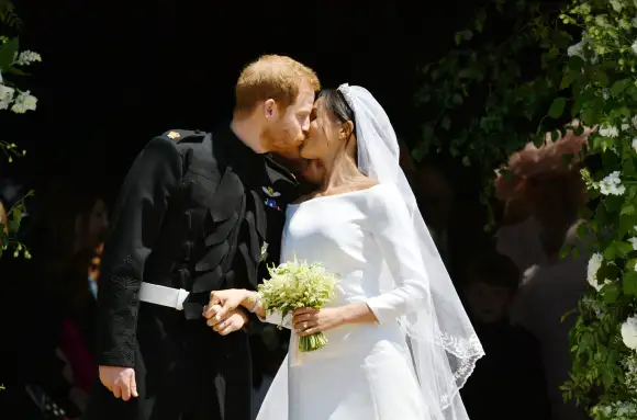 Prince Harry and Meghan Markle kiss on the steps of St George's Chapel in Windsor Castle after their wedding in St George's Chapel at Windsor Castle on May 19, 2018.