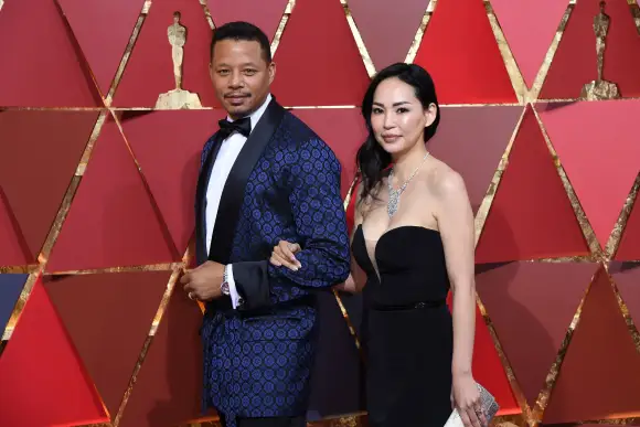 Terrence Howard and Mira Pak pose as they arrive on the red carpet for the 89th Oscars