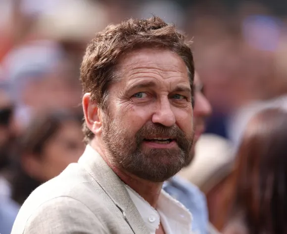 Actor Gerard Butler sits court side on Centre Court during the Mens Final at the 2024 Wimbledon Championships Wimbledon