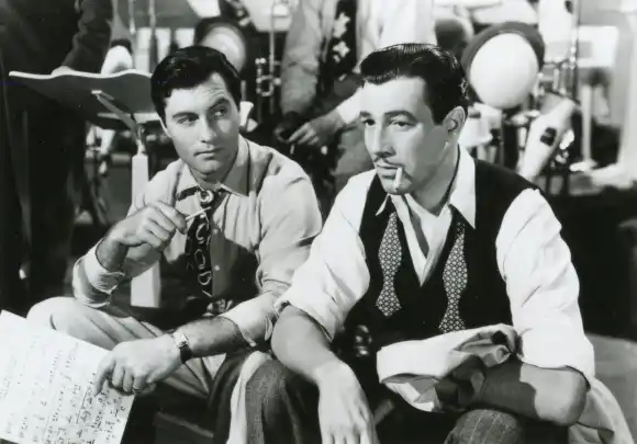 American actors George Montgomery and Cesar Romero in the movie Orchestra Wives, USA 1942 PUBLICATIONxNOTxINxITA