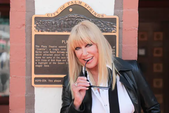 Syndication: The Enquirer Suzanne Somers poses for a photo in front of the Plaza Theatre on March 6, 2019 in Palm Springs.