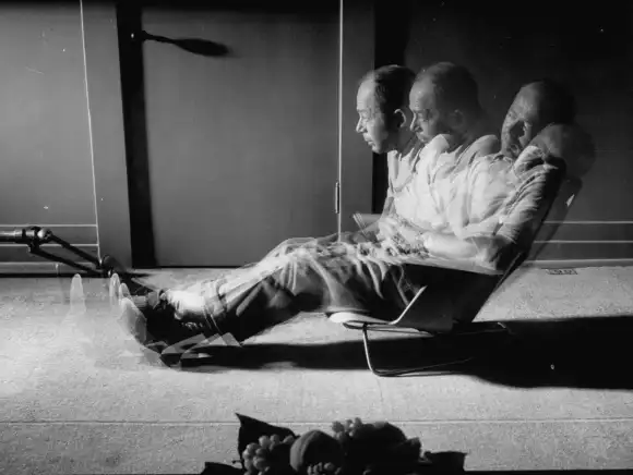 August  1950:  Multiple  exposure  of  film  director  Billy  Wilder  sitting  in  chair  designed