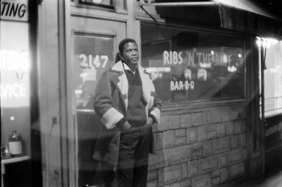 Portrait  of  Sidney  Poitier  standing  in  front  of  his  barbecue  restaurant  'Ribs  in  the  R