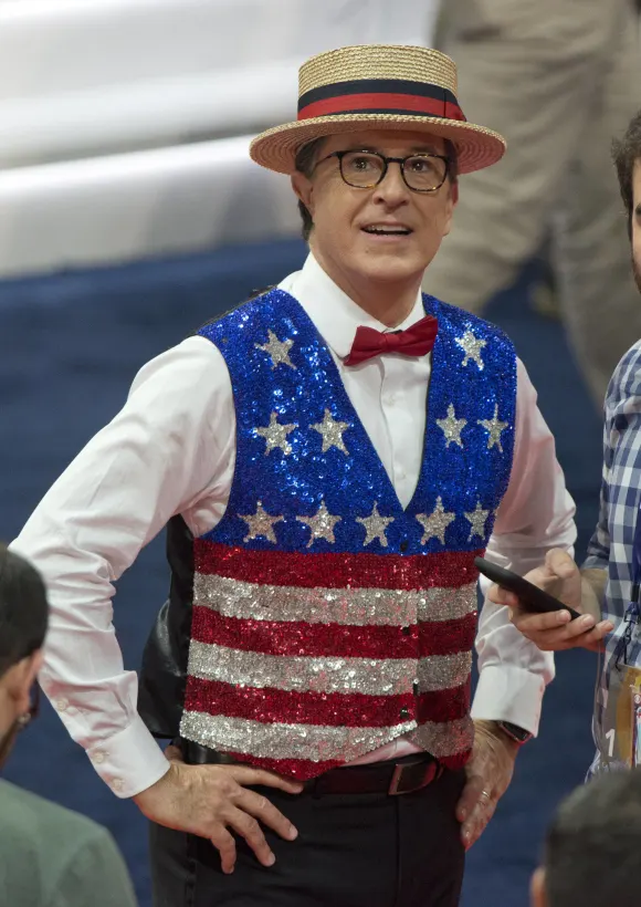 Stephen Colbert, host of The Late Show with Stephen Colbert on CBS-TV, practices a bit in one of the aisles of the floor