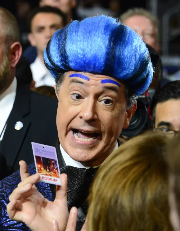 Stephen Colbert, host of The Late Show with Stephen Colbert on CBS-TV, shows off his podium pass as he practices a bit i