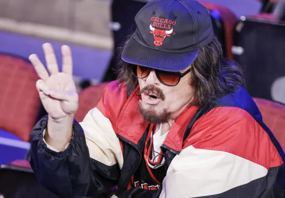 Comedian Steven Colbert is dressed as a Chicago Bulls fan as he appears on the floor of the United Center which will be