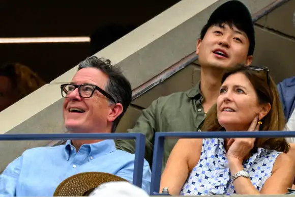 TV personality Stephen Colbert and his wife Evelyn McGee-Colbert look on to watch Grigor Dimitrov of Bulgaria defeat Rus