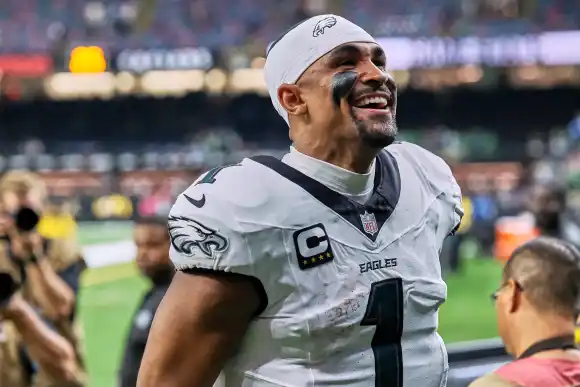 September 22, 2024, New Orleans, Louisiana, U.S: Philadelphia Eagles quarterback Jalen Hurts runs off the field smiling