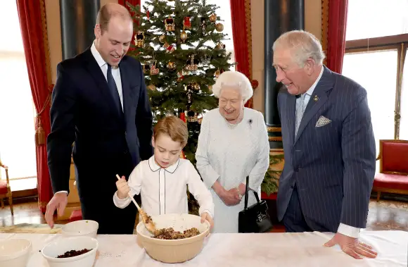 Prince William, Prince George, Queen Elizabeth II and Prince Charles prepare Christmas pudding at Buckingham Palace 2019