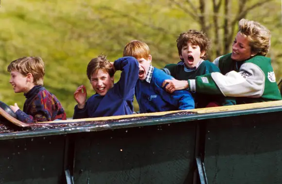 Prince William, Prince Harry, and Lady Diana at an amusement park